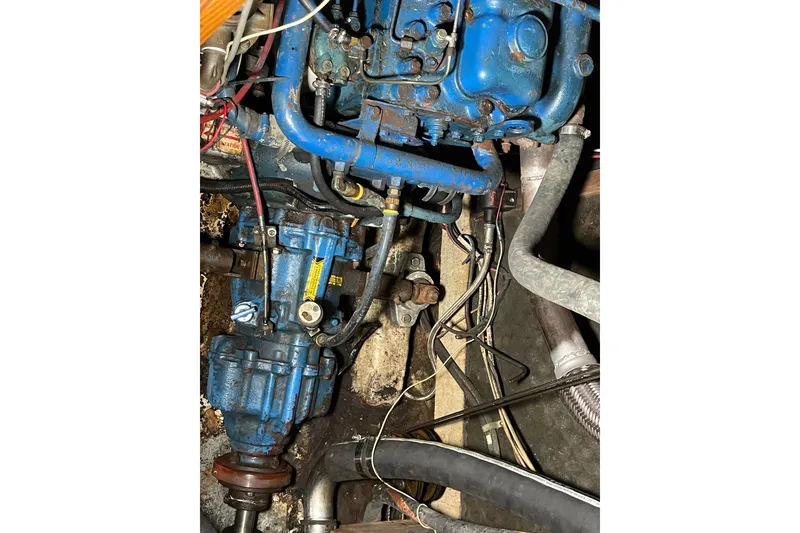 Slide: The Image of Blue engine components of a 1984 TA Chaio CT47, featuring various pipes and wires. - 10