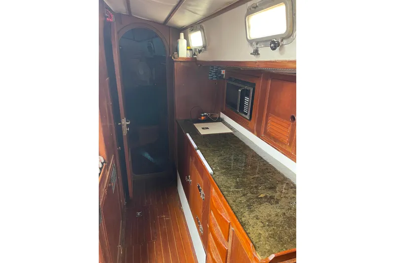 Slide: The Image of 1984 TA Chaio CT47 yacht interior with wooden cabinetry and countertop. - 12