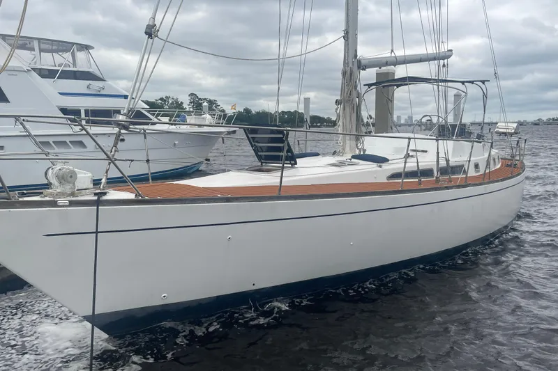 Slide: The Image of 1984 TA Chaio CT47 sailboat on water, featuring sleek design and wooden deck. - 15