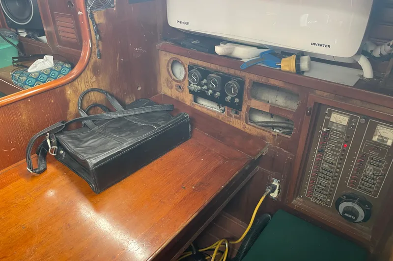 Slide: The Image of 1984 TA Chaio CT47 boat interior with control panel and black bag on wooden desk. - 3