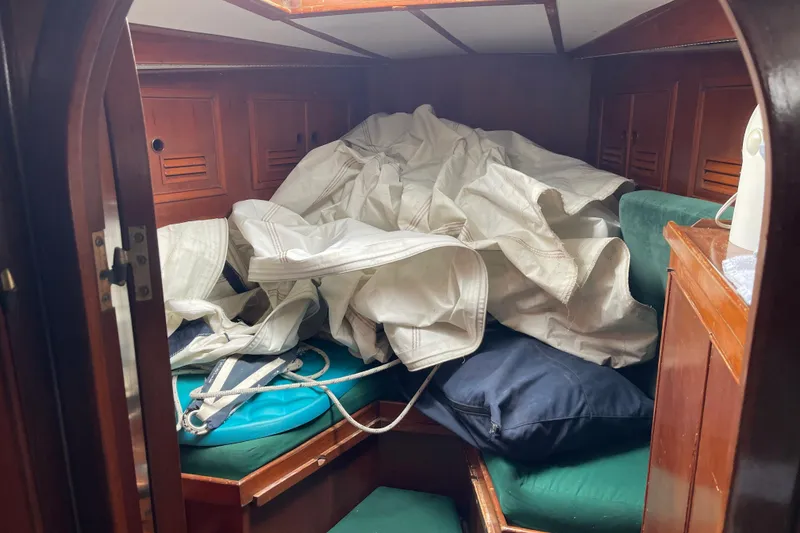 Slide: The Image of Interior of 1984 TA Chaio CT47 sailboat with sails and cushions in cabin. - 6