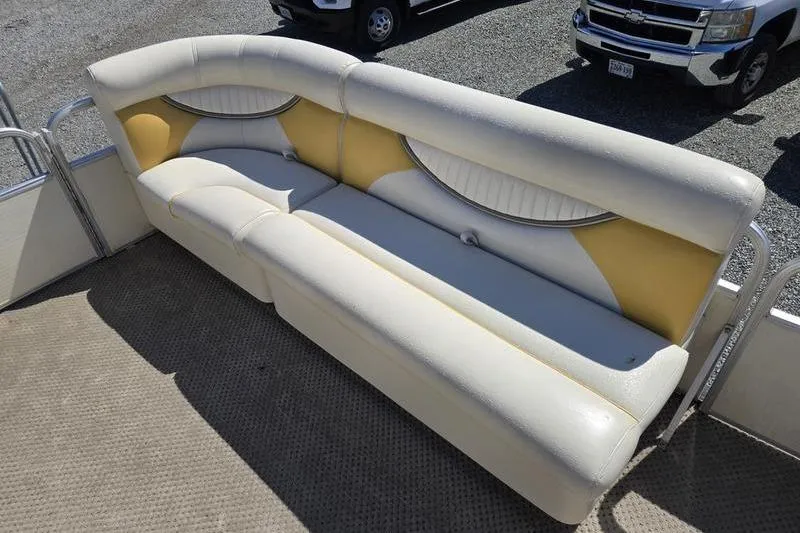 Slide: The Image of 2008 Sweetwater 2386RE boat seating with white and yellow upholstery. - 10