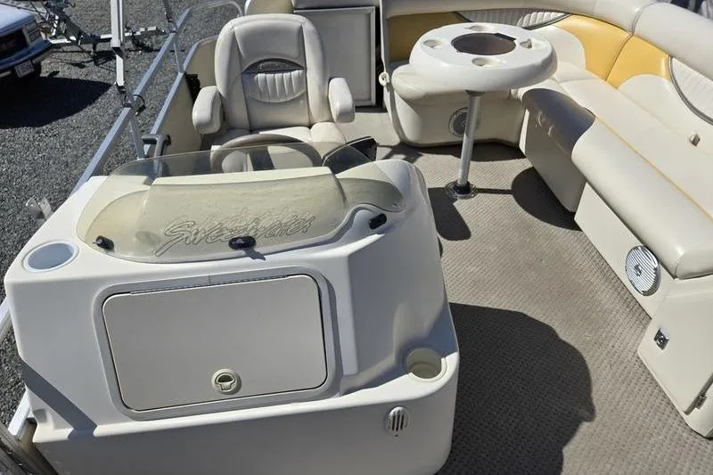 Slide: The Image of Interior of a 2008 Sweetwater 2386RE pontoon boat with seating and table. - 11