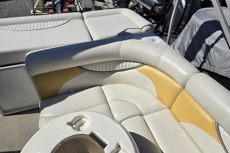 Slide: The Image of 2008 Sweetwater 2386RE boat interior with beige and yellow seating and cup holders. - 15