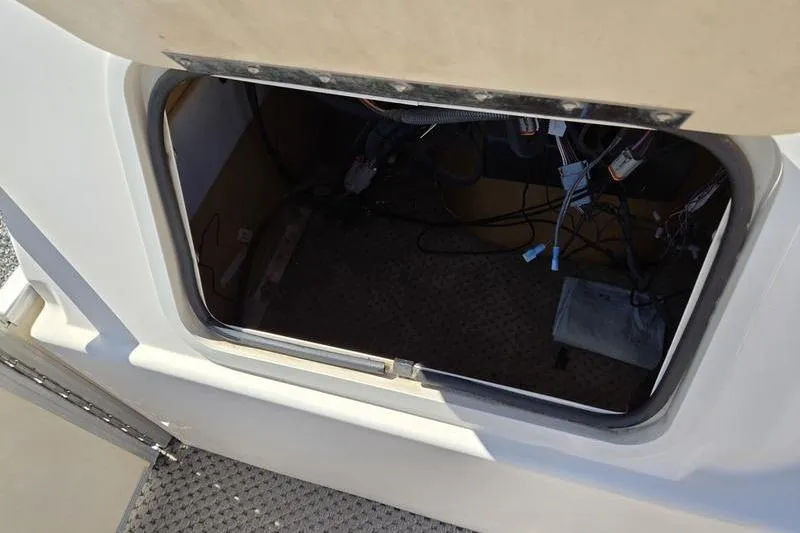 Slide: The Image of Open storage compartment on a 2008 Sweetwater 2386RE boat, showing wiring and interior details. - 18