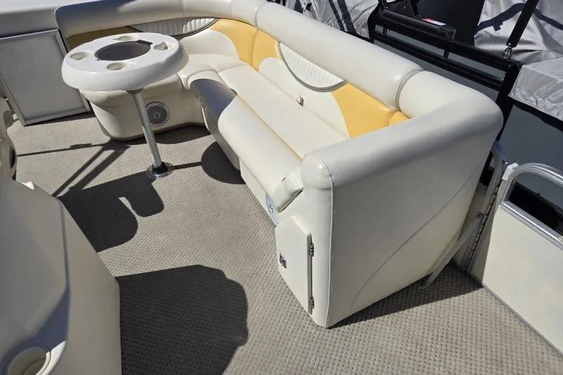 Slide: The Image of 2008 Sweetwater 2386RE boat interior with beige seating and round table. - 19