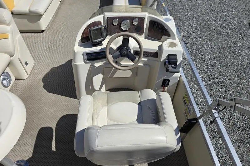 Slide: The Image of 2008 Sweetwater 2386RE boat helm with steering wheel and control panel. - 5