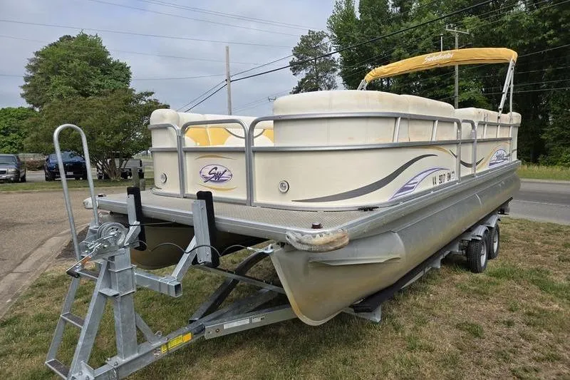 Slide: The Image of 2008 Sweetwater 2386RE pontoon boat on trailer, parked outdoors. - 6