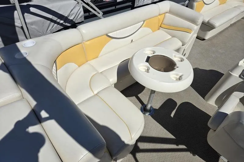 Slide: The Image of 2008 Sweetwater 2386RE boat interior with beige seating and round table. - 7