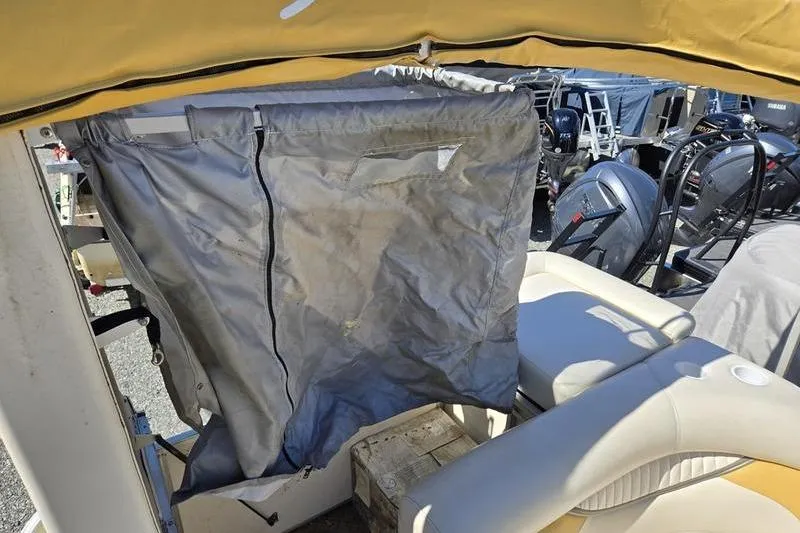 Slide: The Image of 2008 Sweetwater 2386RE boat interior with protective cover and seating. - 8