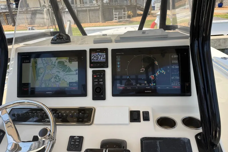 Slide: The Image of Dashboard of a 2015 Cobia 296 Center Console with navigation screens and controls. - 10