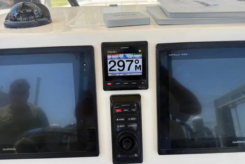 Slide: The Image of Dashboard of a 2015 Cobia 296 Center Console with Garmin navigation displays. - 12