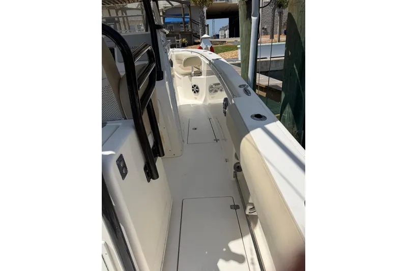 Slide: The Image of 2015 Cobia 296 Center Console boat interior with seating and storage compartments. - 2