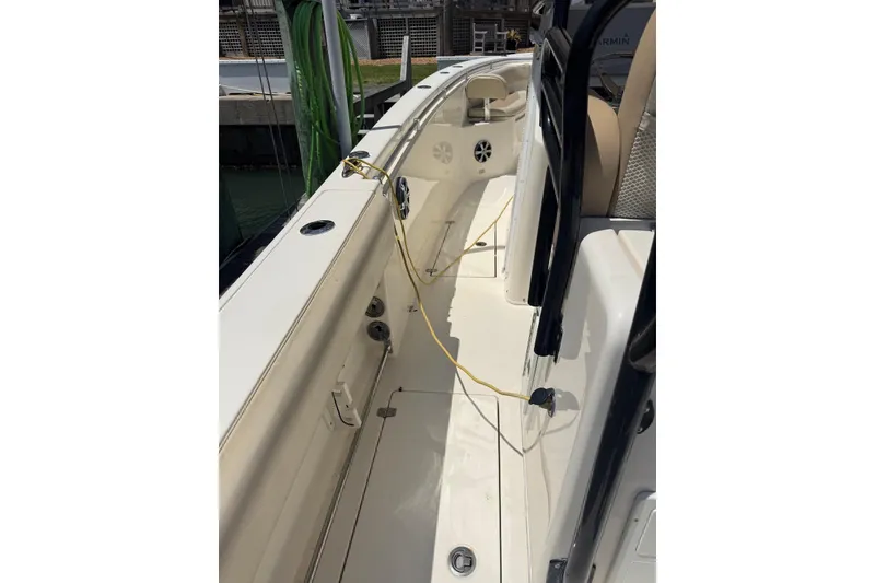 Slide: The Image of 2015 Cobia 296 Center Console boat interior with clean deck and seating area. - 3
