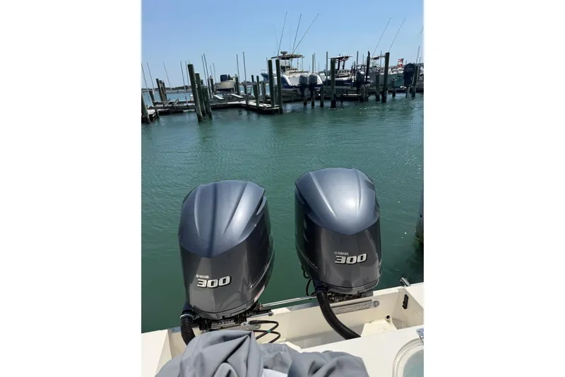 Slide: The Image of 2015 Cobia 296 Center Console with twin Yamaha 300 engines at marina. - 4