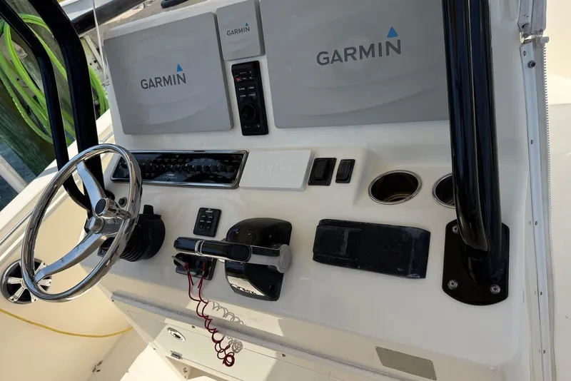 Slide: The Image of Helm of 2015 Cobia 296 Center Console with Garmin navigation system and steering wheel. - 9