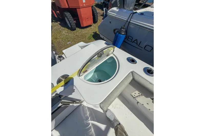 Slide: The Image of 2019 Sportsman Open 282 Center Console boat interior with livewell and rod holders. - 12
