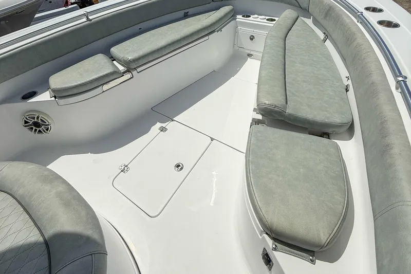 Slide: The Image of 2019 Sportsman Open 282 Center Console boat interior with cushioned seating and storage. - 13