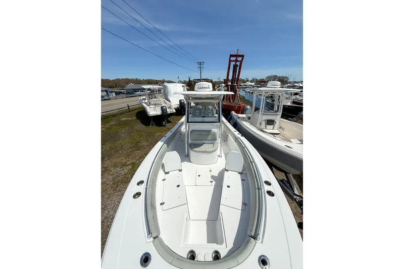 Slide: The Image of 2019 Sportsman Open 282 Center Console boat displayed at a marina. - 17