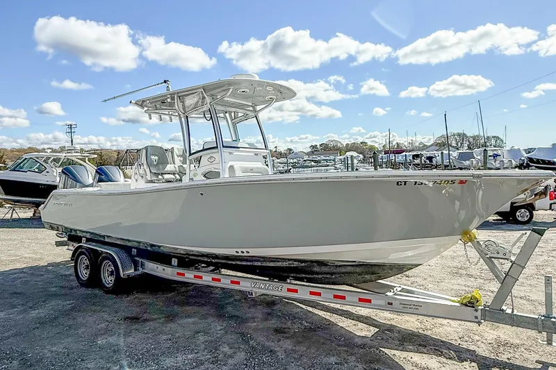 Slide: The Image of 2019 Sportsman Open 282 Center Console boat on trailer under blue sky. - 4
