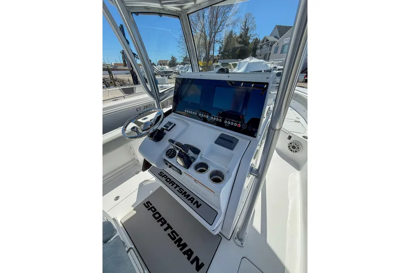 Slide: The Image of 2019 Sportsman Open 282 Center Console boat dashboard with steering wheel and controls. - 6