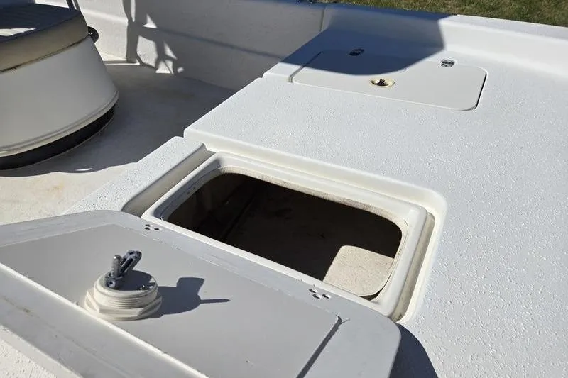 Slide: The Image of 2017 Carolina Skiff 19 DLX boat deck with open storage compartment. - 12