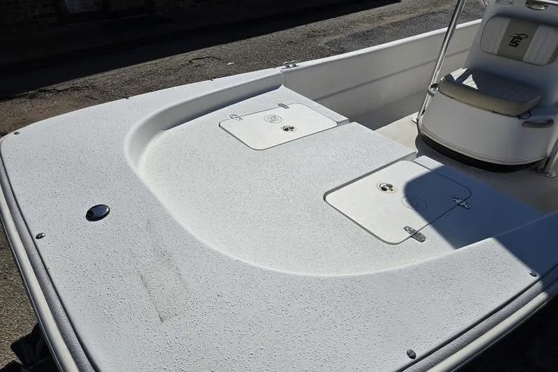 Slide: The Image of 2017 Carolina Skiff 19 DLX boat deck with storage compartments and seating. - 14