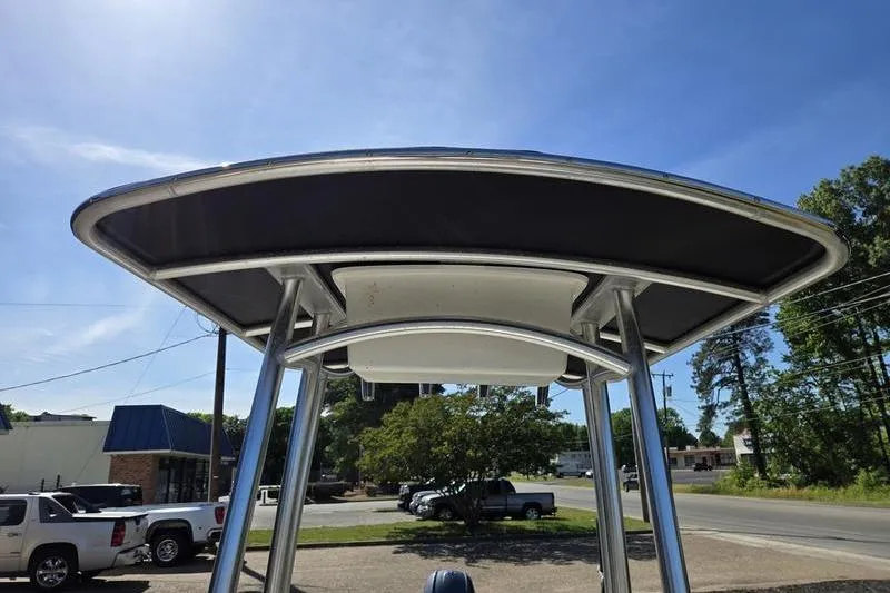 Slide: The Image of T-top of a 2017 Carolina Skiff 19 DLX boat under a clear blue sky. - 16