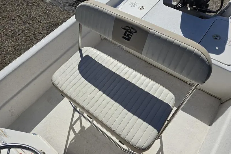 Slide: The Image of 2017 Carolina Skiff 19 DLX boat seat with logo, featuring white and gray upholstery. - 6