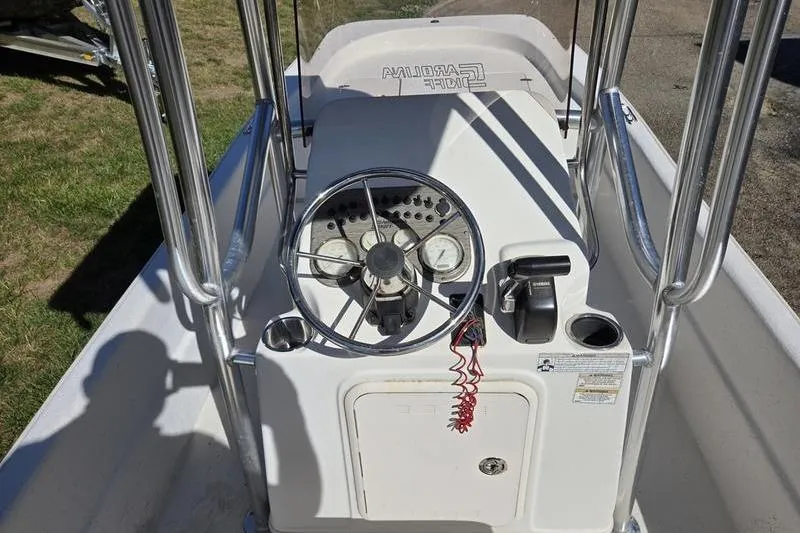 Slide: The Image of 2017 Carolina Skiff 19 DLX boat console with steering wheel and gauges. - 7
