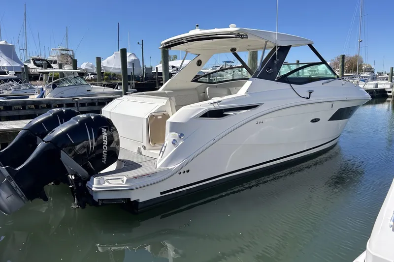 The Image of 2021 Sea Ray Sundancer 320 boat docked with twin Mercury outboard engines. - 0