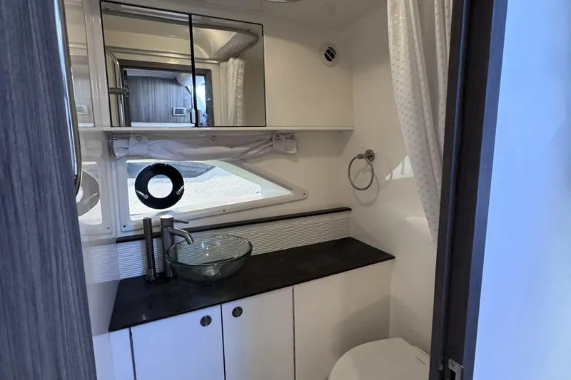 Slide: The Image of 2021 Sea Ray Sundancer 320 bathroom with modern sink and mirror. - 14