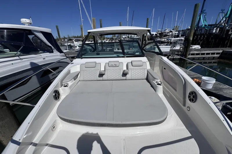 Slide: The Image of 2021 Sea Ray Sundancer 320 boat docked, featuring spacious seating and modern design. - 16