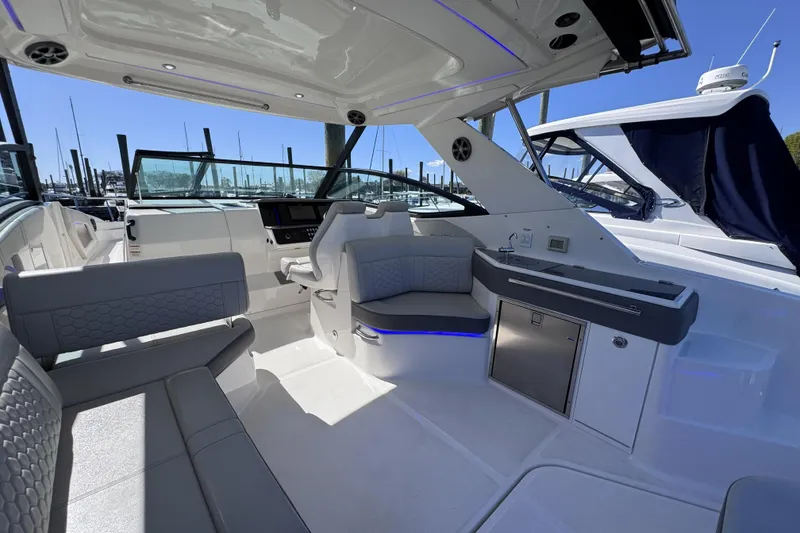 Slide: The Image of 2021 Sea Ray Sundancer 320 interior with seating, kitchenette, and modern design. - 5