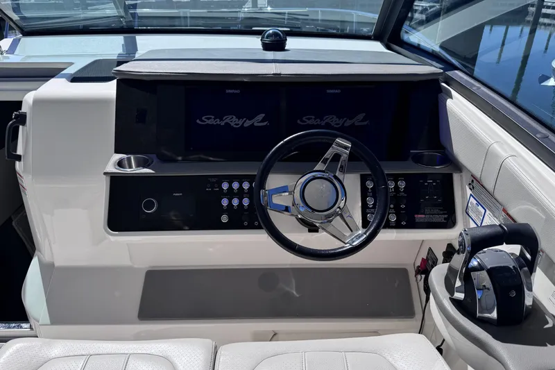 Slide: The Image of 2021 Sea Ray Sundancer 320 helm with modern steering and control panel. - 9