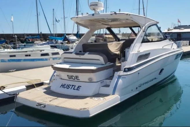 The Image of 2016 Regal 35 Sport Coupe yacht docked at marina, rear view. - 0