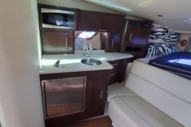Slide: The Image of Interior of 2016 Regal 35 Sport Coupe with kitchenette and seating area. - 12