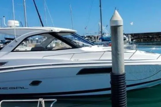 Slide: The Image of 2016 Regal 35 Sport Coupe docked in a marina under clear blue skies. - 4