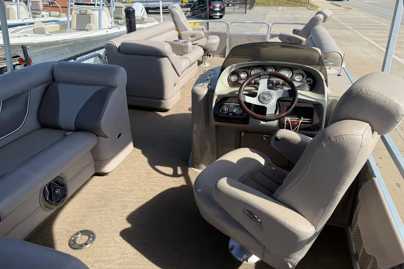 Slide: The Image of Interior of a 2008 Premier 250 Escapade pontoon boat with plush seating and steering console. - 10