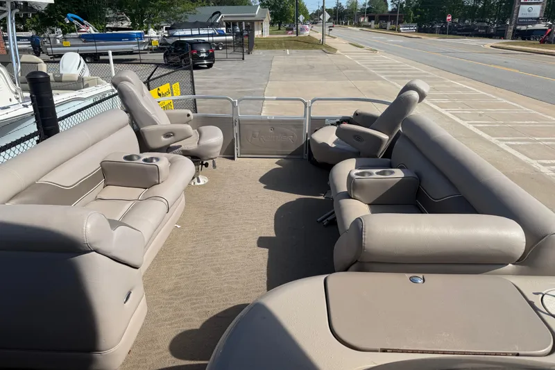 Slide: The Image of Interior of a 2008 Premier 250 Escapade pontoon boat with beige seating. - 12