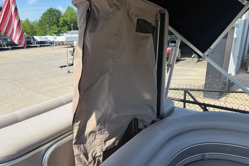 Slide: The Image of 2008 Premier 250 Escapade pontoon boat interior with canopy and seating, outdoors. - 13