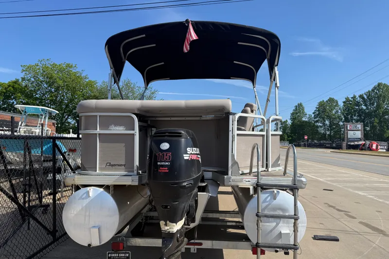 Slide: The Image of 2008 Premier 250 Escapade pontoon boat with Suzuki 115 outboard motor, parked outdoors. - 14