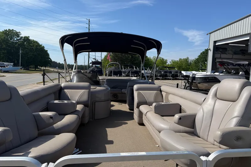 Slide: The Image of 2008 Premier 250 Escapade pontoon boat with spacious seating and canopy, parked outdoors. - 5