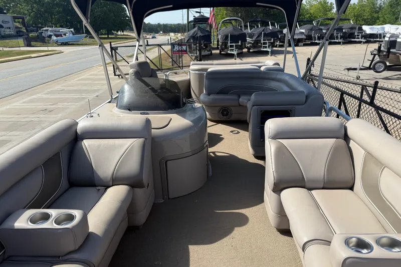 Slide: The Image of 2008 Premier 250 Escapade pontoon boat with beige seating and cup holders. - 7