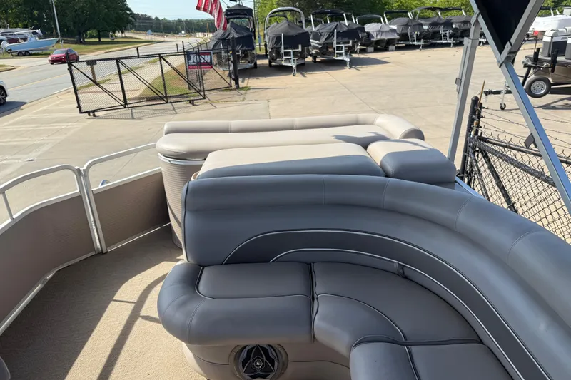 Slide: The Image of 2008 Premier 250 Escapade pontoon boat with gray seating, parked outdoors. - 9