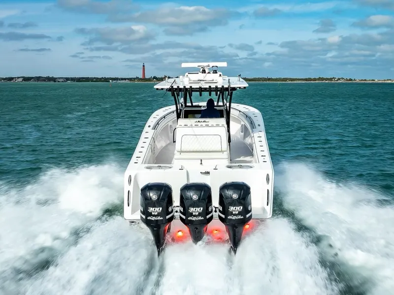 Slide: The Image of 2020 SeaHunter 35 Tournament boat with triple 300 horsepower engines cruising on open water. - 15
