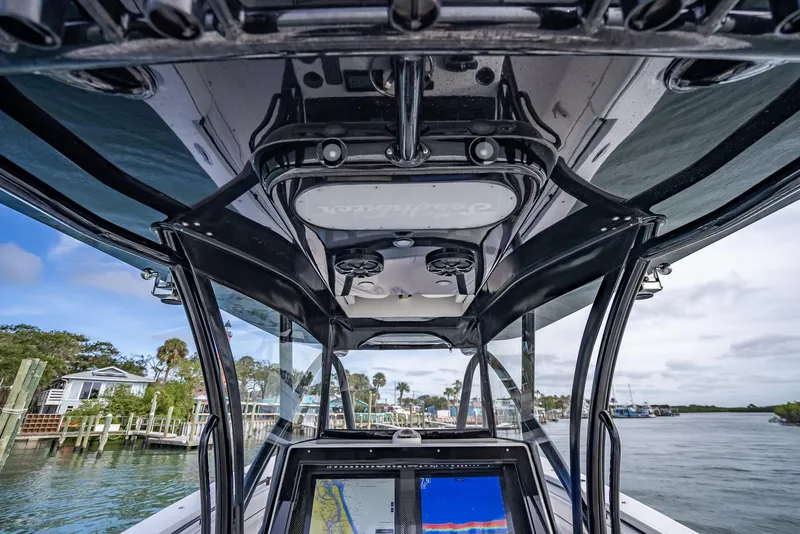 Slide: The Image of 2020 SeaHunter 35 Tournament boat console with navigation screens and overhead storage. - 27