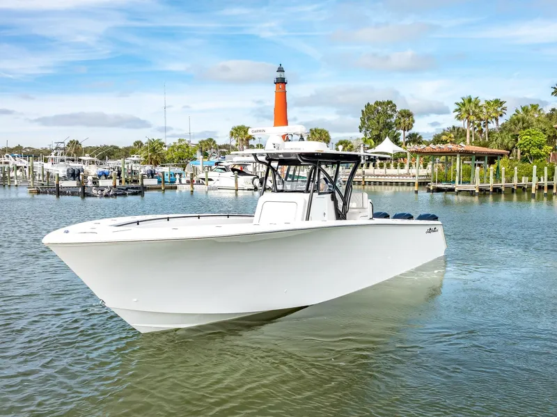 Slide: The Image of 2020 SeaHunter 35 Tournament boat in a marina with a lighthouse in the background. - 9