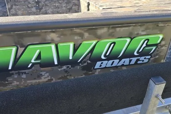 Slide: The Image of 2026 Havoc 1860 DBST boat with camouflage design and bold green logo. - 12