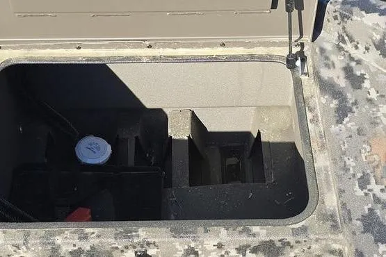 Slide: The Image of Open storage compartment in 2026 Havoc 1860 DBST boat, featuring camouflage pattern. - 5